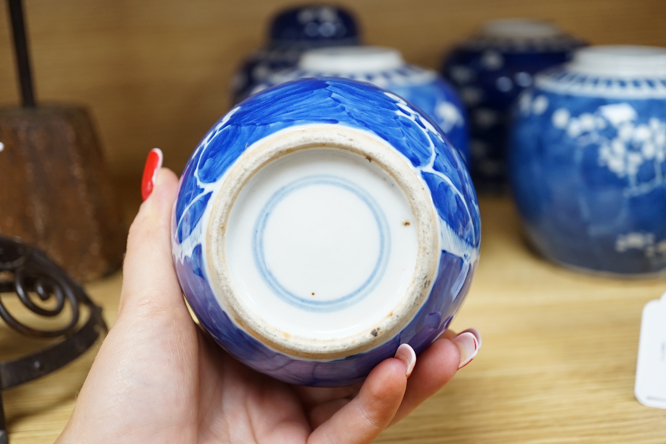 Five Chinese blue and white prunus ginger jars, one with cover- 15cm high and another jar